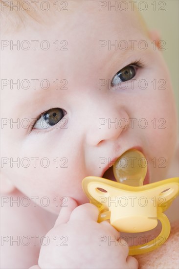 Close up of baby with pacifier. Date: 2008