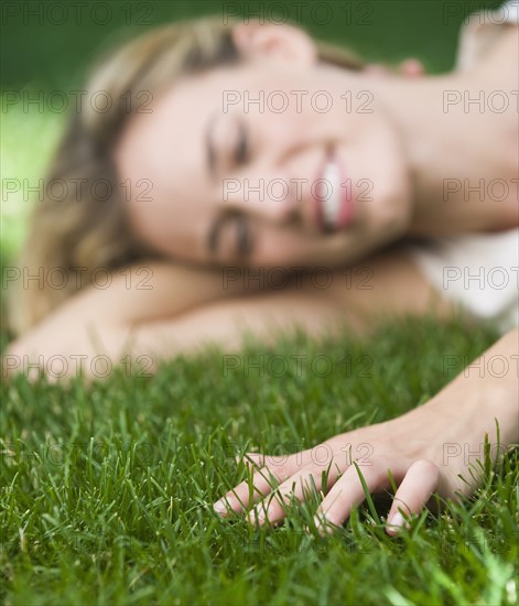 Woman laying in grass.