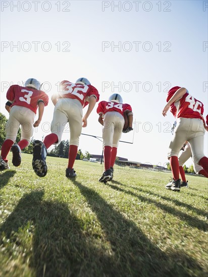 Football players running onto field. Date: 2008