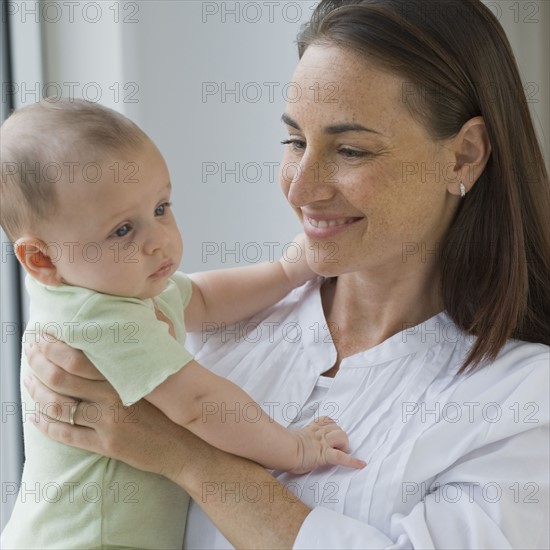 Mother holding baby son.