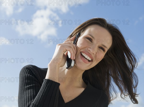 Close up of smiling woman talking on cell phone.