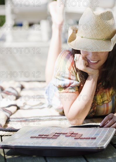 Woman playing scrabble on deck. Date : 2008