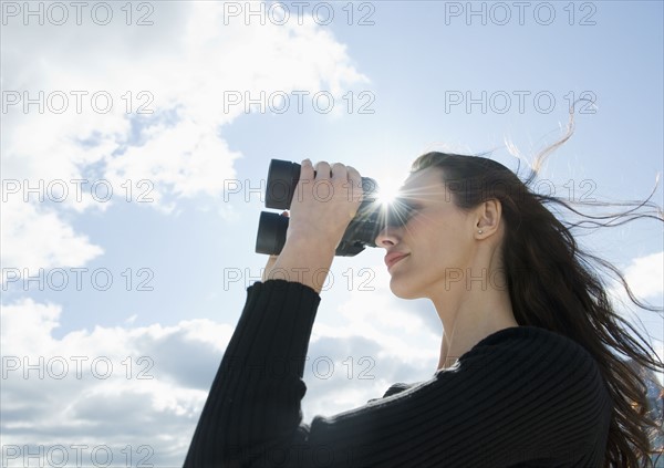 Woman looking through binoculars.