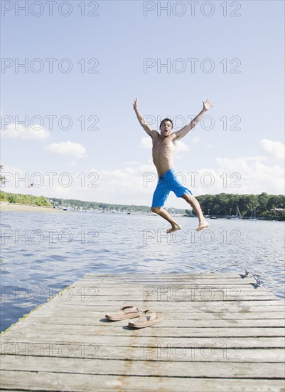 Portrait of man jumping off dock into lake. Date: 2008