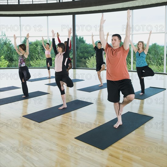 Yoga class in mountain pose. Date: 2008