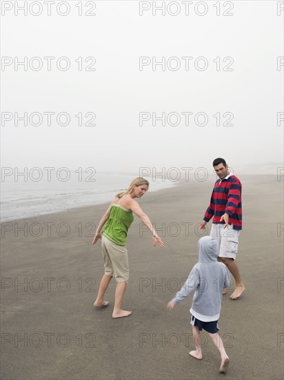 Parents and son on beach. Date: 2008
