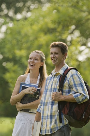 College students with books and backpack. Date : 2008