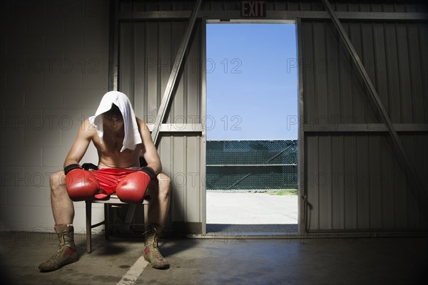 Boxer sitting on stool near doorway. Date : 2008