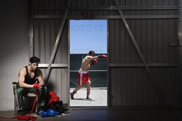 Boxers wrapping hands and practicing. Date: 2008