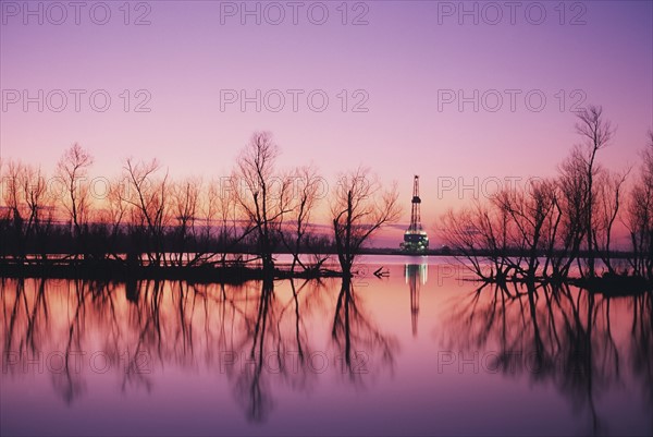 Oil platform in distance at sunset, Louisiana. Date : 2008