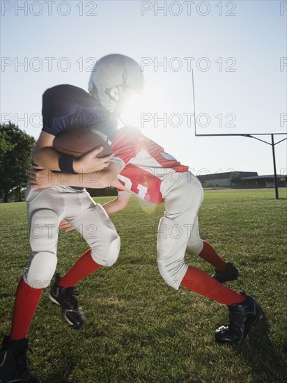 Football player tackling opponent. Date : 2008