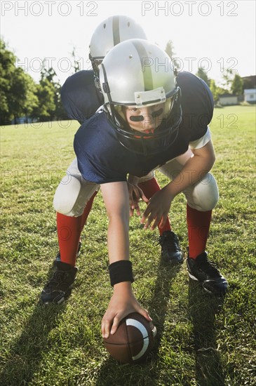 Football center preparing to snap football. Date : 2008