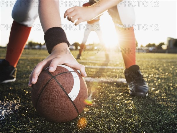 Close up of football center preparing to snap football. Date: 2008