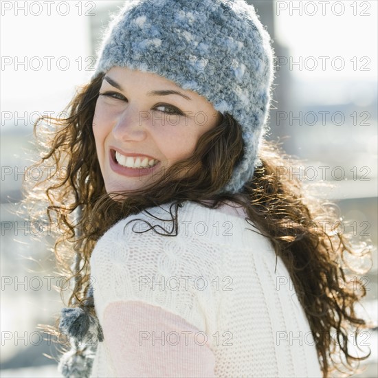 Portrait of woman smiling in stocking cap.