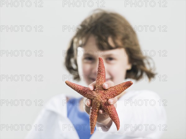 Portrait of girl holding starfish. Date : 2008