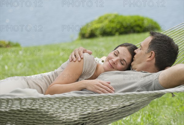 Couple laying in hammock.