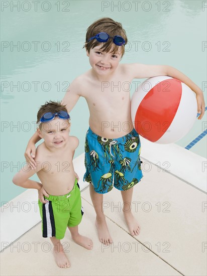 Brothers posing by swimming pool. Date: 2008