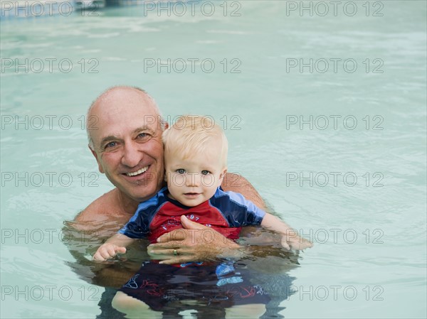 Grandfather and grandson posing in swimming pool. Date : 2008