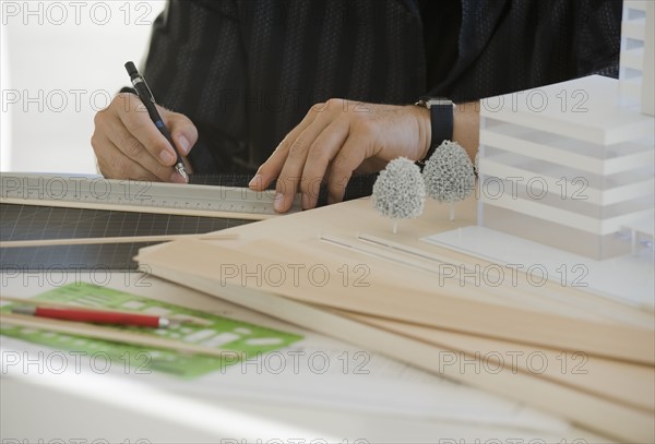 Architect working on building model.