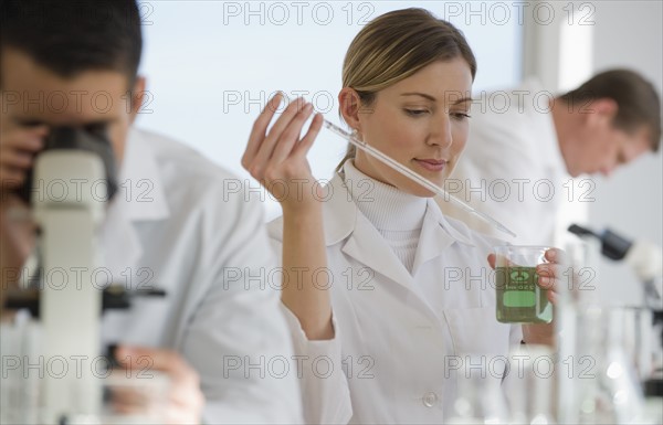 Scientists experimenting in pharmaceutical laboratory.
