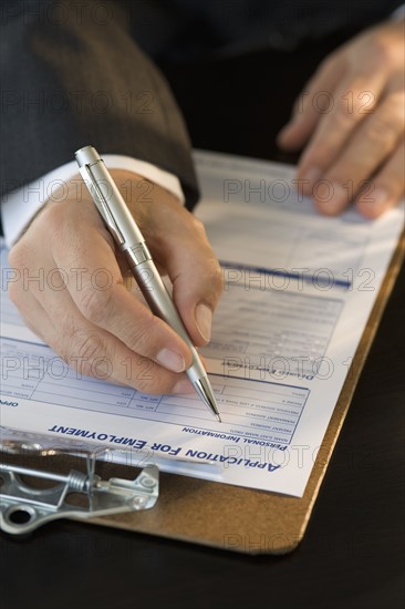 Man filling out employment application.