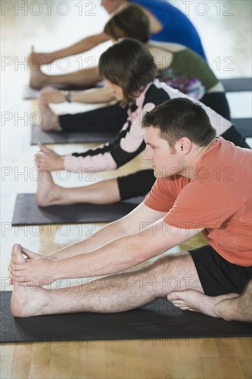 Fitness class stretching on mats. Date : 2008