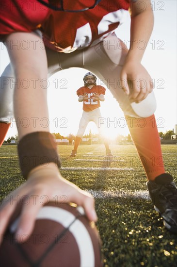 Football center preparing to snap football to quarterback. Date : 2008