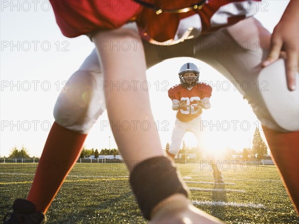 Football center preparing to snap football to quarterback. Date: 2008