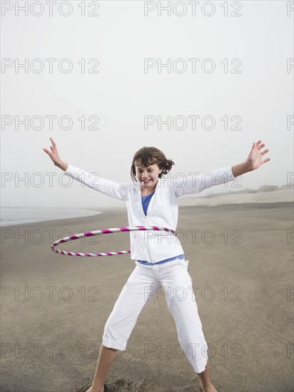 Portrait of girl with hula hoop on beach. Date : 2008