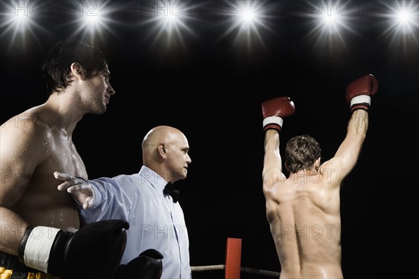 Referee holding losing boxer back from winner. Date : 2008