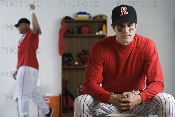 Baseball player looking pensive in locker room. Date: 2008