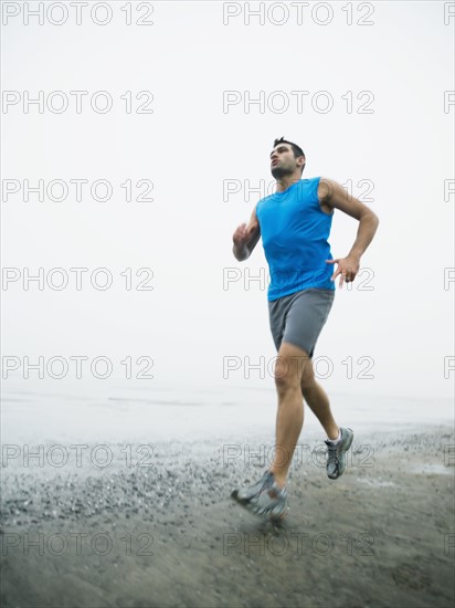 Man jogging on foggy beach. Date: 2008