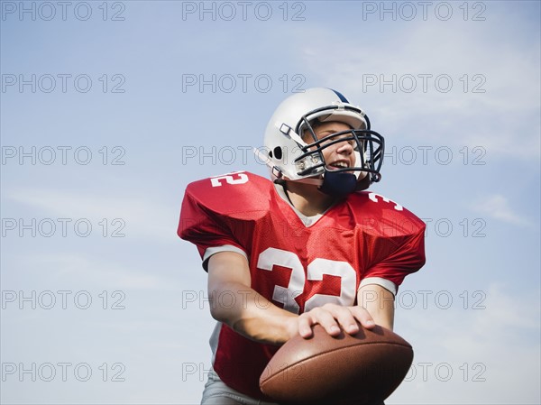 Quarterback holding football. Date: 2008