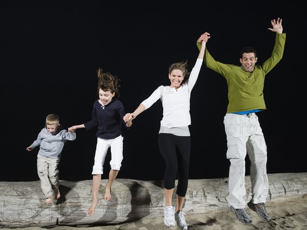 Family jumping off driftwood. Date: 2008