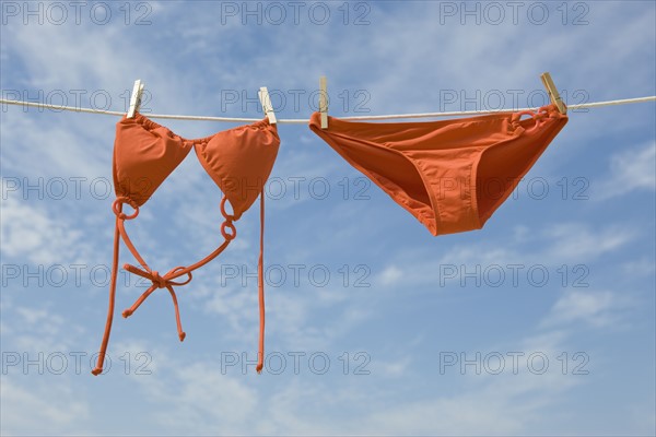 Bikini hanging from clothesline.