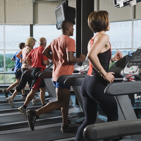 Men and women running on treadmills. Date: 2008