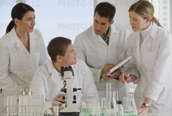 Scientists working together in pharmaceutical laboratory.