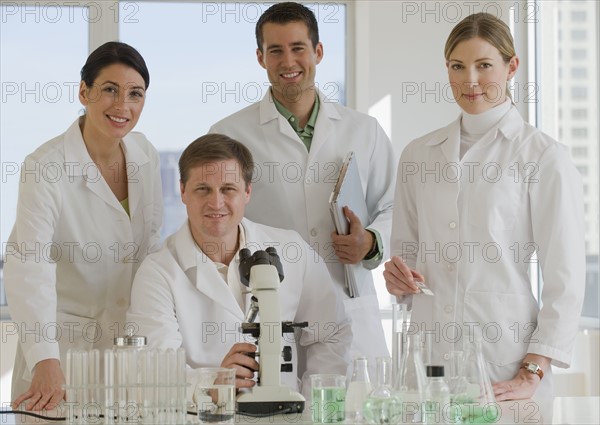 Scientists posing in pharmaceutical laboratory.