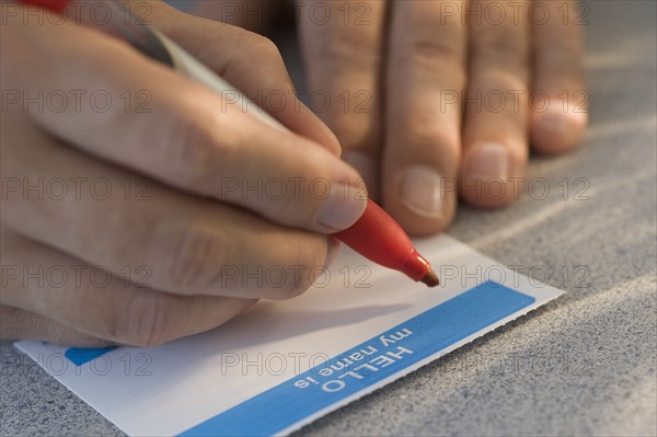 Man filling out name tag.