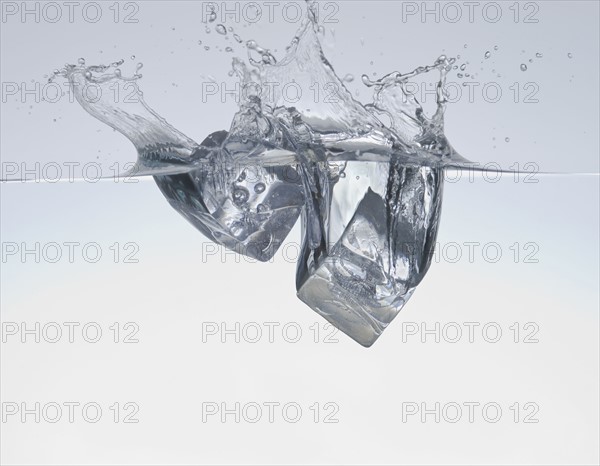 Ice cubes splashing in water.