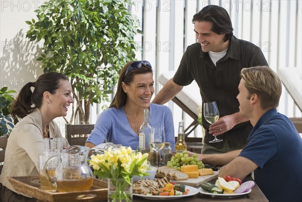 Couples dining on patio.