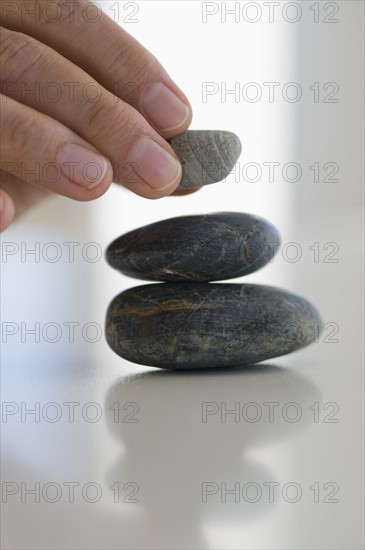 Hand stacking stones.