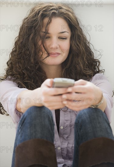 Woman text messaging on cell phone.