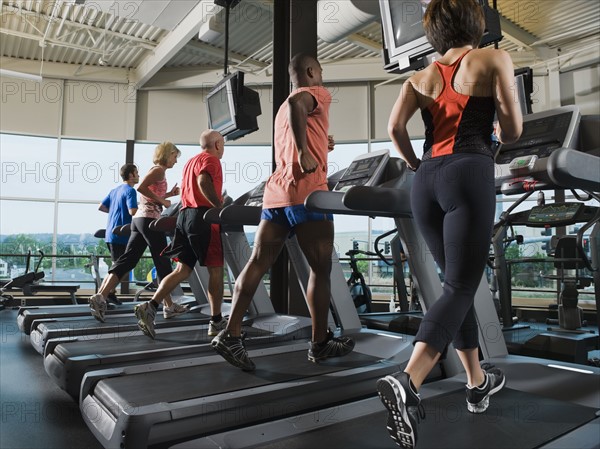 Men and women running on treadmills. Date: 2008