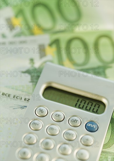Calculator and 100 euro notes.