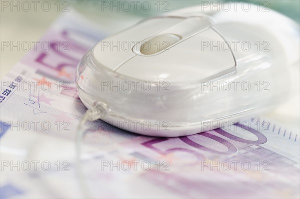 Euro notes and computer mouse.