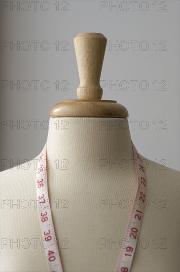 Measuring tape on dressmakers model.