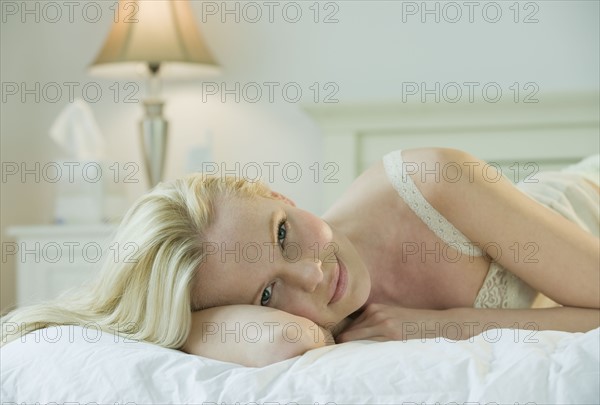 Woman relaxing on bed.