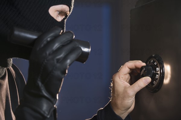 Burglar cracking safe.