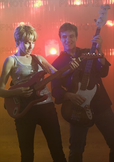 Performers playing electric guitars.